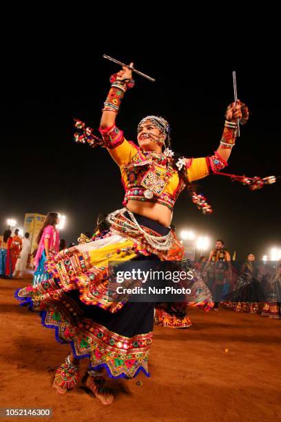 Indian men and women perform Garba &amp; Dandiya dance during the Navratri festival 'nine days' celebration in Jaipur,Rajasthan,India on Oct...