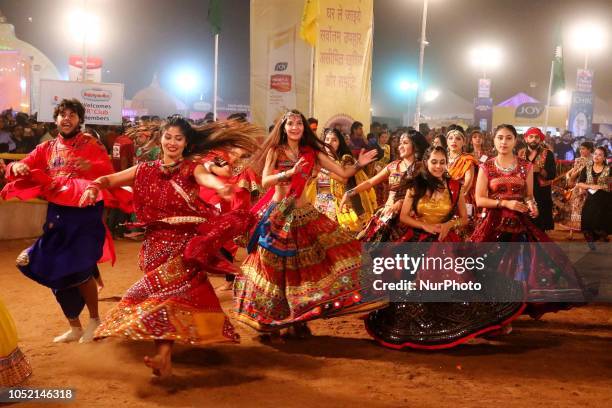 Indian men and women perform Garba &amp; Dandiya dance during the Navratri festival 'nine days' celebration in Jaipur,Rajasthan,India on Oct...