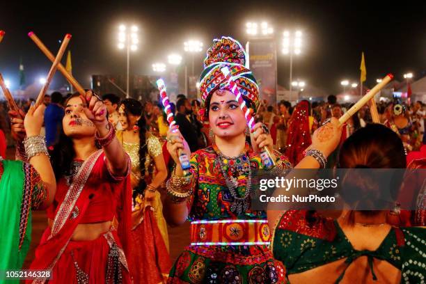 Indian men and women perform Garba &amp; Dandiya dance during the Navratri festival 'nine days' celebration in Jaipur,Rajasthan,India on Oct...