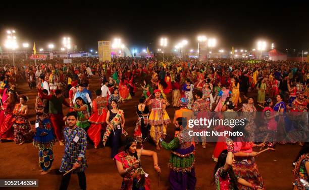 Indian men and women perform Garba &amp; Dandiya dance during the Navratri festival 'nine days' celebration in Jaipur,Rajasthan,India on Oct...