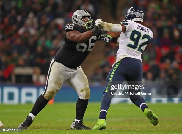 Offensive guard Gabe Jackson of the Oakland Raiders and defensive tackle Nazair Jones of the Seattle Seahawks tussle during NFL action at Wembley...