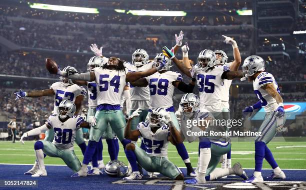 The Dallas Cowboys defensive line celebrates a fumble recovery against the Jacksonville Jaguars in the third quarter of a game at AT&T Stadium on...