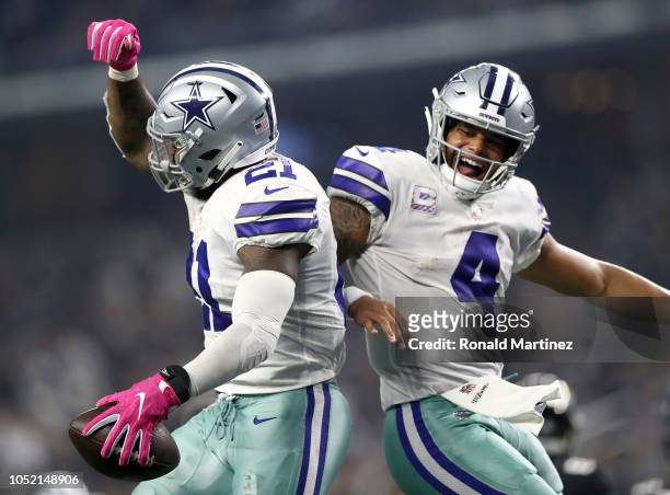 Ezekiel Elliott and Dak Prescott of the Dallas Cowboys celebrate the fourth quarter touchdown against the Jacksonville Jaguars at AT&T Stadium on...