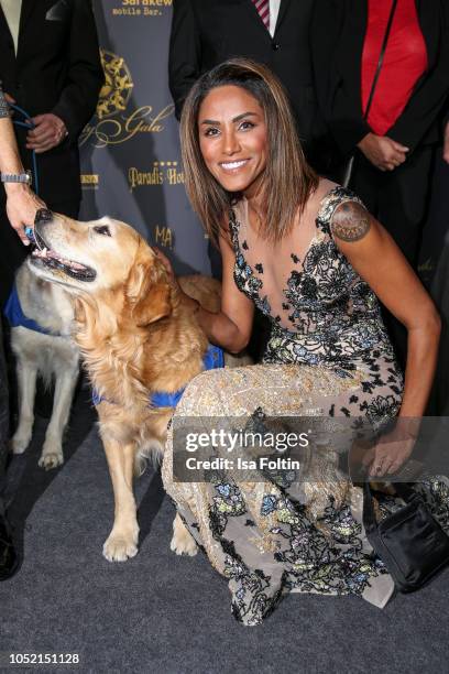German singer Sabrina Setlur with an assistance dog during the 9th VITA Charity Gala at Kurhaus Wiesbaden on October 13, 2018 in Wiesbaden, Germany.