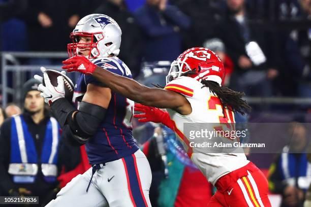 Rob Gronkowski of the New England Patriots makes a catch while under pressure from Josh Shaw of the Kansas City Chiefs in the fourth quarter of a...