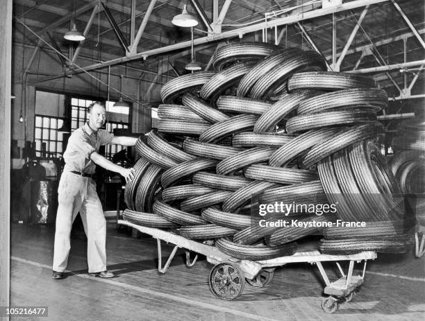 An Employee Of A Rubber Company Pushing A Wheelbarrow Loaded With Rubber Tires In Akron, Ohio On August 23, 1945.