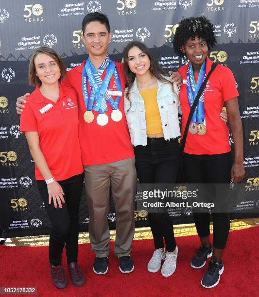Special Olympics athletes Brett Laza, Kyla Schilz and Krystal Johnson pose with Gabriella Martinez at the Special Olympics Pier Del Sol held at...