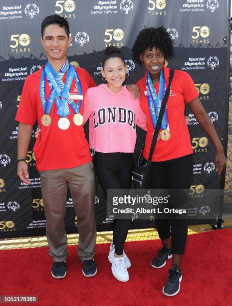 Special Olympics athletes Brett Laza and Krystal Johnson pose with Breana Raquel at Special Olympics Pier Del Sol held at Pacific Park on the Santa...