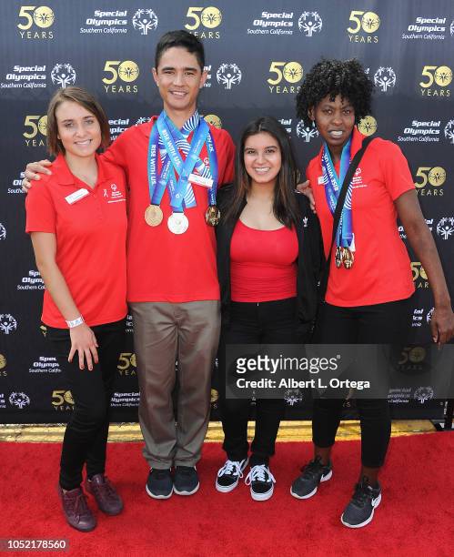 Special Olympics athletes Brett Laza, Kyla Schilz and Krystal Johnson pose with Amber Romero at the Special Olympics Pier Del Sol held at Pacific...