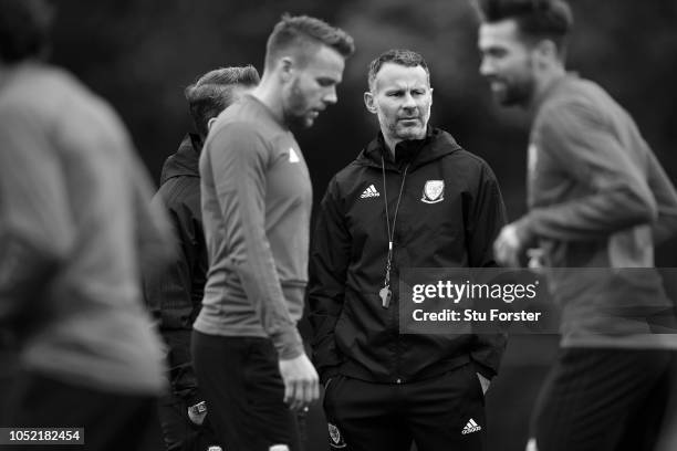 Ryan Giggs, Manager of Wales looks on as his team train during a Wales training session at Vale Resort on October 15, 2018 in Cardiff, Wales.