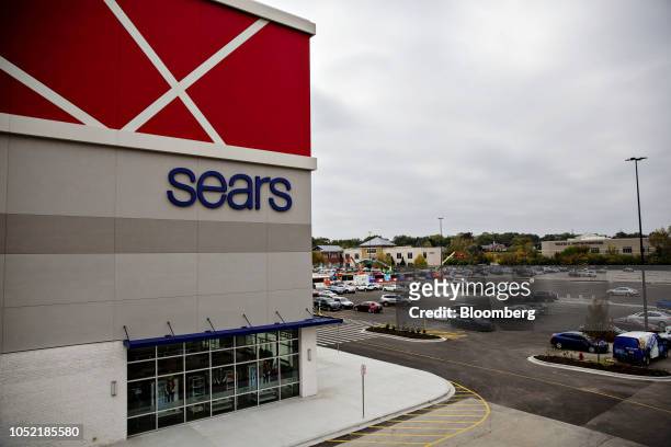 Vehicles sit parked outside a newly renovated Sears Holdings Corp. Store in Oak Brook, Illinois, U.S., on Sunday, Oct. 14, 2018. The company filed...