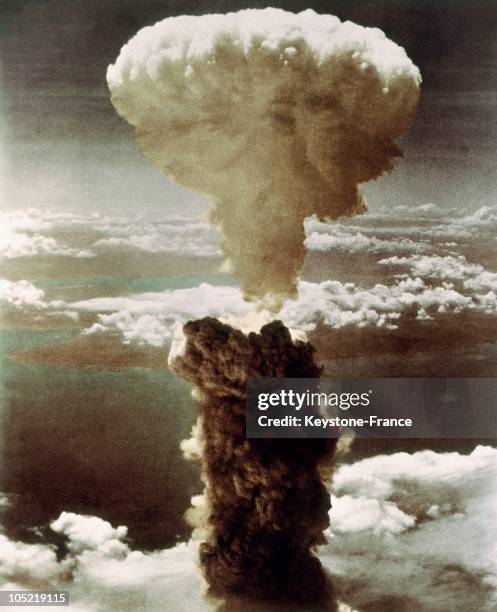 Dense column of smoke, capped by a mushroom cloud, rises more than 60,000 feet into the air over the Japanese port of Nagasaki after the explosion of...