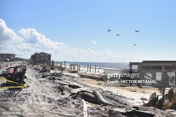 The presidential helicopter Marine One is seen flying along with Osprey planes over the areas destroyed by Hurricane Michael, in Mexico Beach, on...