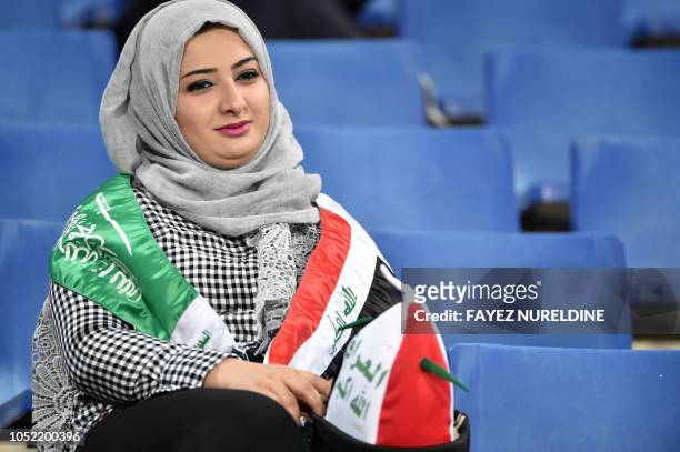 An Iraqi woman living in Riyadh watches a friendly football match between Saudi Arabia and Iraq for the "Superclassico" championship at King Saud...