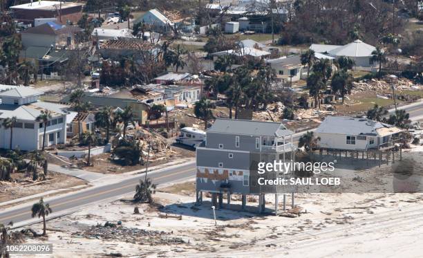 Damaged buildings are seen from a helicopter as US President Donald Trump and First Lady Melania Trump tour damage from Hurricane Michael on the...