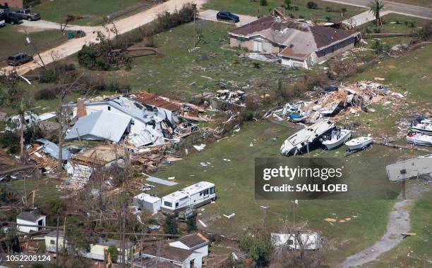 Damaged buildings are seen from a helicopter as US President Donald Trump and First Lady Melania Trump tour damage from Hurricane Michael on the...