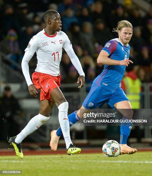 Switzerland's midfielder Denis Zakaria and Iceland's midfielder Birkir Bjarnason vie for the ball during the UEFA Nations League Group Stage football...