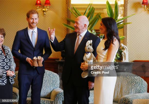 Prince Harry, Duke of Sussex and Meghan, Duchess of Sussex look at a plush kangaroo with Australia's Governor General Peter Cosgrove and wife Lynne...