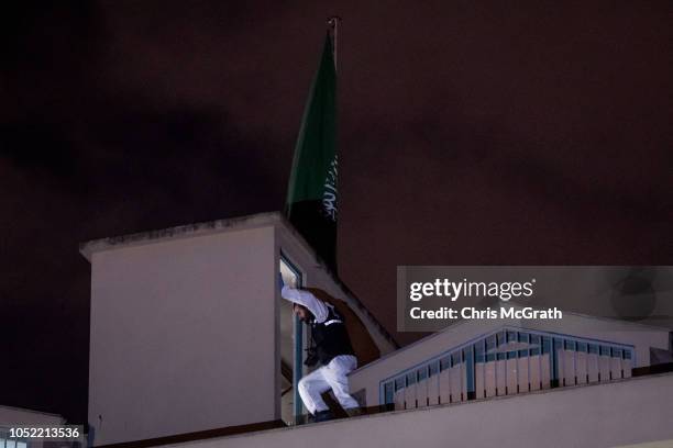 Turkish police officer looks around the roof top of the Saudi Arabian consulate amid a growing international backlash to the disappearance of...