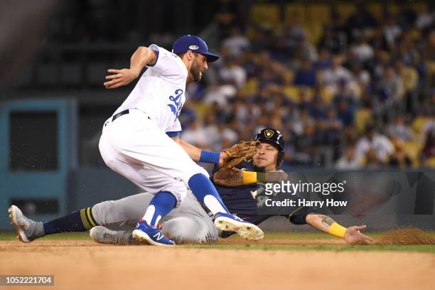 Chris Taylor of the Los Angeles Dodgers tags out Hernan Perez of the Milwaukee Brewers as he is caught attempting to steal second base during the...