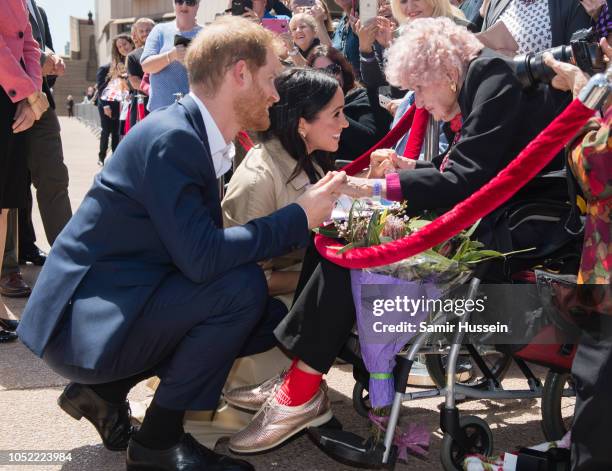 Prince Harry, Duke of Sussex and Meghan, Duchess of Sussex greet royal fan and war widow Daphne Dunne as they arrive for a public walkabout at the...