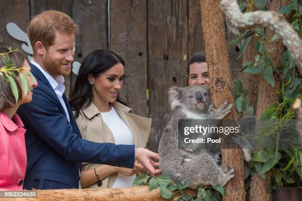 Prince Harry, Duke of Sussex and Meghan, Duchess of Sussex meet a Koala called Ruby during a visit to Taronga Zoo on October 16, 2018 in Sydney,...