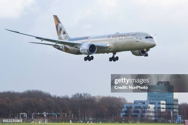 Etihad Airways Boeing 787-9 Dreamliner landing at Amsterdam Schiphol International Airport in Runway 27 during a rainy day. Etihad Airways connects...