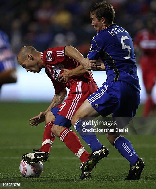 Freddie Ljungberg of the Chicago Fire is held by Matt Besler of the Kansas City Wizards in an MLS match on October 12, 2010 at Toyota Park in...