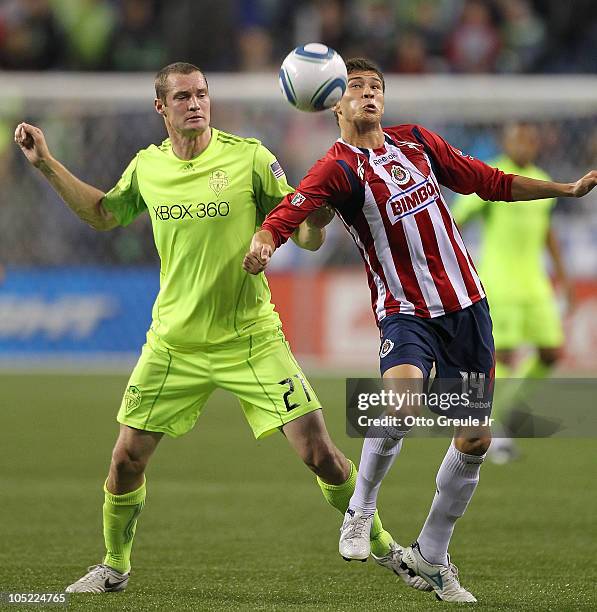 Jorge Enriquez of Chivas de Guadalajara battles Nate Jaqua of the Seattle Sounders FC on October 12, 2010 at Qwest Field in Seattle, Washington.