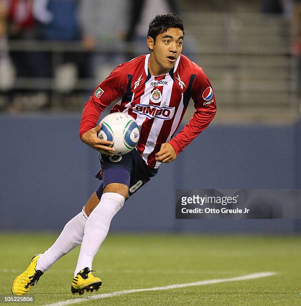 Marco Fabian of Chivas de Guadalajara celebrates after scoring a goal against the Seattle Sounders FC on October 12, 2010 at Qwest Field in Seattle,...