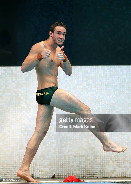 Matthew Mitcham of Australia celebrates after making a dive in the Men's 10m Platform Preliminary at the Dr. S.P. Mukherjee Aquatics Complex during...
