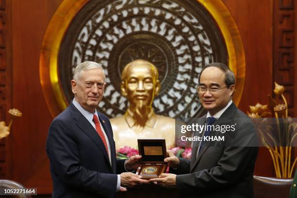 Secretary of Defense Jim Mattis and Ho Chi Minh City's communist party chief Nguyen Thien Nhan hold a commemorative plaque during a meeting in Ho Chi...