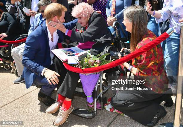 Prince Harry, Duke of Sussex greets royal fan and war widow Daphne Dunne at the Sydney Opera House on October 16, 2018 in Sydney, Australia. The Duke...