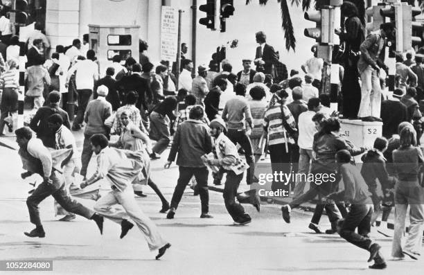 Demonstrators run away from a police charge during racial riots, in Cape town, in October 1976. After violent clashes in Soweto on June 1976, new...