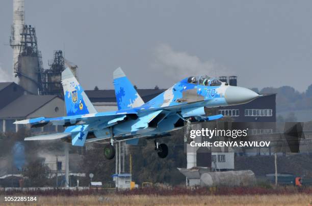 Picture taken on October 12 shows the Ukrainian Su-27 UB fighter flights during an air force exercises on Starokostyantyniv military airbase. -...