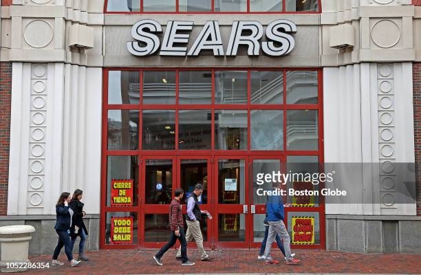 Pedestrians pass the entrance to the closing Sears store at the CambridgeSide Galleria in Cambridge, MA on Oct. 15, 2018. Signs for a...