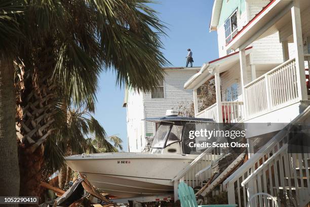 Roofer replaces the roof on a town home after it was damaged by Hurricane Michael on October 16, 2018 in Mexico Beach, Florida. Hurricane Michael...