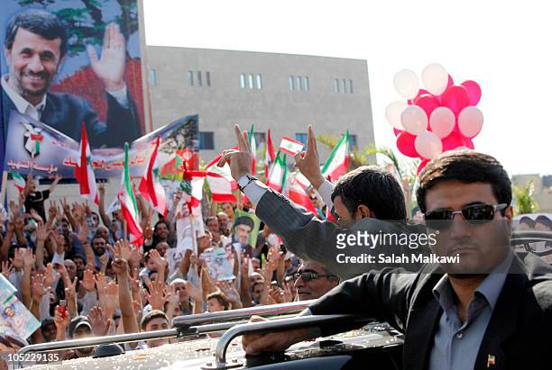 Iranian President Mahmoud Ahmadinejad waves to the crowed in southern suberb of Beirut upon his arrival on October 13, 2010 in Lebanon. The...
