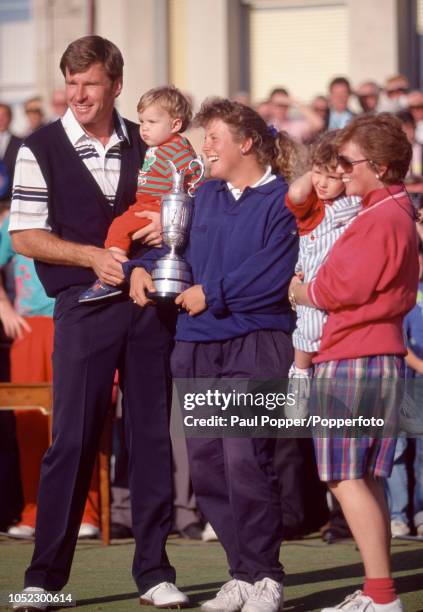 Nick Faldo of England with his family - wife Gill, daughter Natalie and son Mathew - and his caddy, Fanny Sunesson holding the Claret Jug, following...