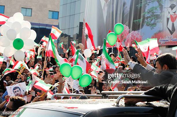 Iranian President Mahmoud Ahmadinejad waves to the crowd in southern suberb of Beirut upon his arrival on October 13, 2010 in Lebanon. The...