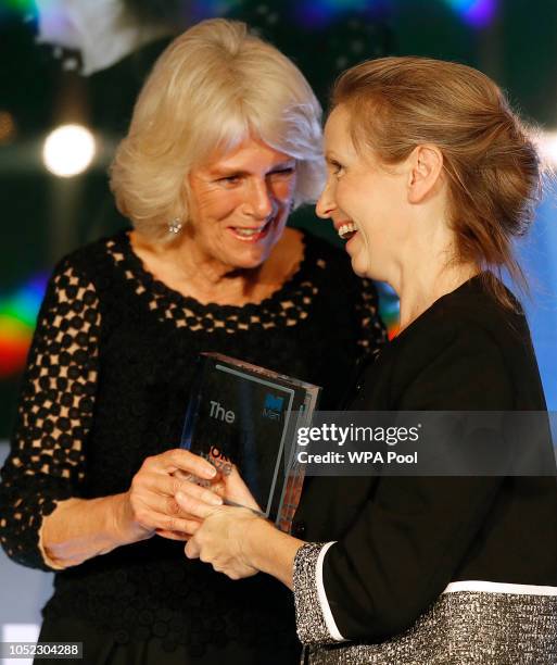 Camilla, Duchess of Cornwall presents writer Anna Burns with the Man Booker Prize for Fiction 2018 during the prize's 50th year, at the Guildhall on...