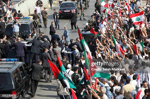 Iranian President Mahmoud Ahmadinejad waves to the crowed in southern suberb of Beirut upon his arrival on October 13, 2010 in Lebanon. The...