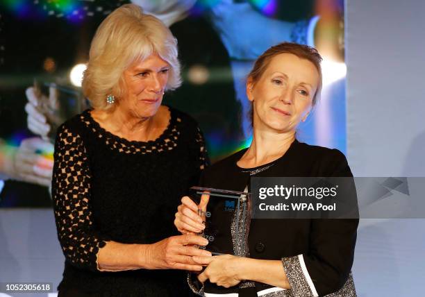 Camilla, Duchess of Cornwall presents writer Anna Burns with the Man Booker Prize for Fiction 2018 during the prize's 50th year, at the Guildhall on...