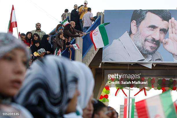 Lebanese people welcome Iranian President Mahmoud Ahmadinejad as he arrives in southern suberb of Beirut on October 13, 2010 in Lebanon. The...