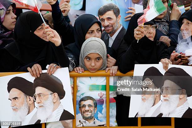 Lebanese people welcome Iranian President Mahmoud Ahmadinejad as he arrives in southern suberb of Beirut on October 13, 2010 in Lebanon. The...