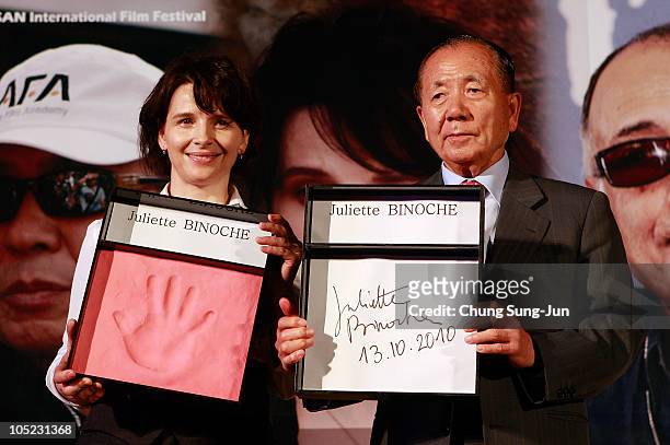 Actress Juliette Binoche and festival director Kim Dong-Ho attend a hand printing ceremony at the Haeundae beach during the 15th Pusan International...