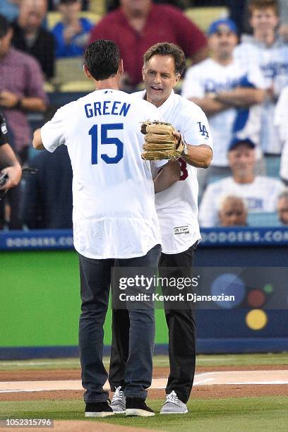 Former Los Angeles Dodgers Shawn Green and Eric Karros react after Shawn Green threw out the first pitch prior to Game Four of the National League...