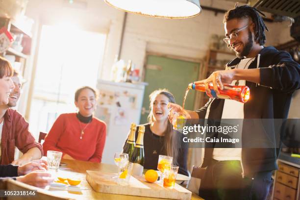 young adult friends making cocktails in apartment kitchen - preparation stock pictures, royalty-free photos & images