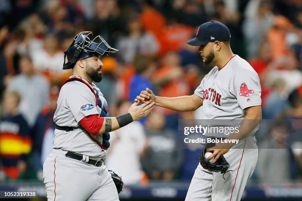 Sandy Leon celebrates with Eduardo Rodriguez of the Boston Red Sox after defeating the Houston Astros 8-2 in Game Three of the American League...