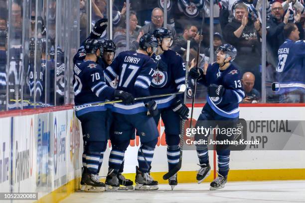 Joe Morrow, Andrew Copp, Adam Lowry, Tyler Myers and Brandon Tanev of the Winnipeg Jets celebrate a first period goal against the Edmonton Oilers at...